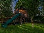 Treehouse slide at dusk